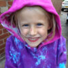 girl wearing a hoody tie dyed with purple, jade a pink