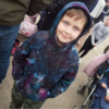 boy wearing a custom tie dyed hoody in a nebula design with hand painted stars