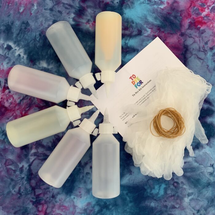 picture of 6 bottles lay flat with instructions, gloves and rubber bands