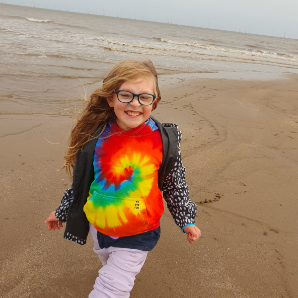 child wearing a tie dyed rainbow hoody