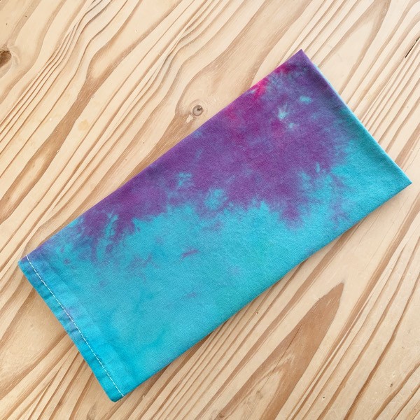 tea towel tie dyed with purple, pink and turquosie