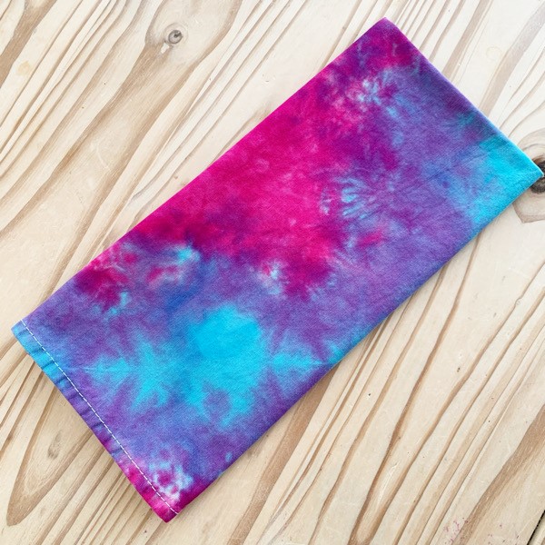 tea towel tie dyed with purple, pink and turquosie