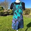 pinafore dress tie dyed in a black peacock colourway with teal, purple, blue and black
