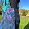 pinafore dress tie dyed in a black peacock colourway with teal, purple, blue and black