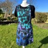 pinafore dress tie dyed in a black peacock colourway with teal, purple, blue and black