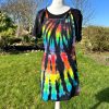 pinafore dress tie dyed in a black rainbow colourway with red, orange, yellow, green, turquoise and purple slashed through with black