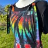 pinafore dress tie dyed in a black rainbow colourway with red, orange, yellow, green, turquoise and purple slashed through with black