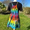 pinafore dress tie dyed in a black rainbow colourway with red, orange, yellow, green, turquoise and purple slashed through with black