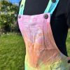 Short dungarees tie dyed in my pale rainbow colourway with pastel pink, orange, yellow, green, turquoise and purple.