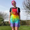 pinafore dress tie dyed in a rainbow colourway with red, orange, yellow, green, turquoise and purple.