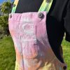 Short dungarees tie dyed in my pale rainbow colourway with pastel pink, orange, yellow, green, turquoise and purple.