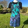 pinafore dress tie dyed in a black peacock colourway with teal, purple, blue and black