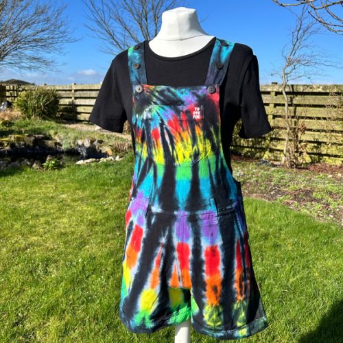 Short dungarees tie dyed in my black rainbow colourway with red, orange, yellow, green, turquoise and purple slashed with black.