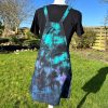 pinafore dress tie dyed in a black peacock colourway with teal, purple, blue and black