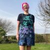 pinafore dress tie dyed in a black peacock colourway with teal, purple, blue and black