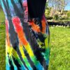 pinafore dress tie dyed in a black rainbow colourway with red, orange, yellow, green, turquoise and purple slashed through with black