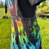 pinafore dress tie dyed in a black rainbow colourway with red, orange, yellow, green, turquoise and purple slashed through with black