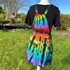 pinafore dress tie dyed in a black rainbow colourway with red, orange, yellow, green, turquoise and purple slashed through with black