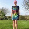 pinafore dress tie dyed in a black rainbow colourway with red, orange, yellow, green, turquoise and purple slashed through with black